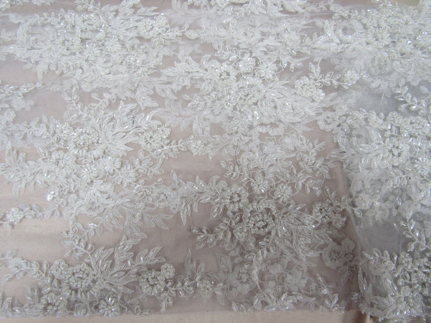 Gorgeous white French design embroider and beaded on a mesh lace. Wedding/Bridal/Prom/Nightgown fabric. - New Creations Fabric & Foam Inc