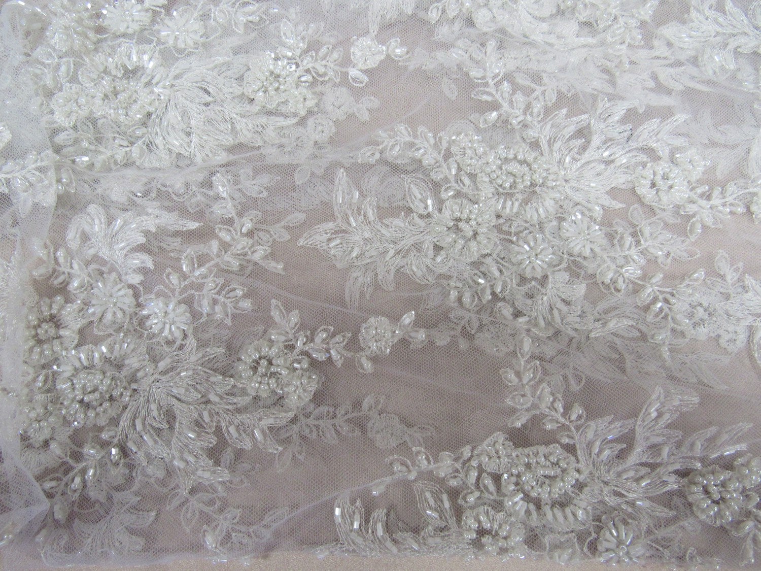Gorgeous white French design embroider and beaded on a mesh lace. Wedding/Bridal/Prom/Nightgown fabric. - New Creations Fabric & Foam Inc