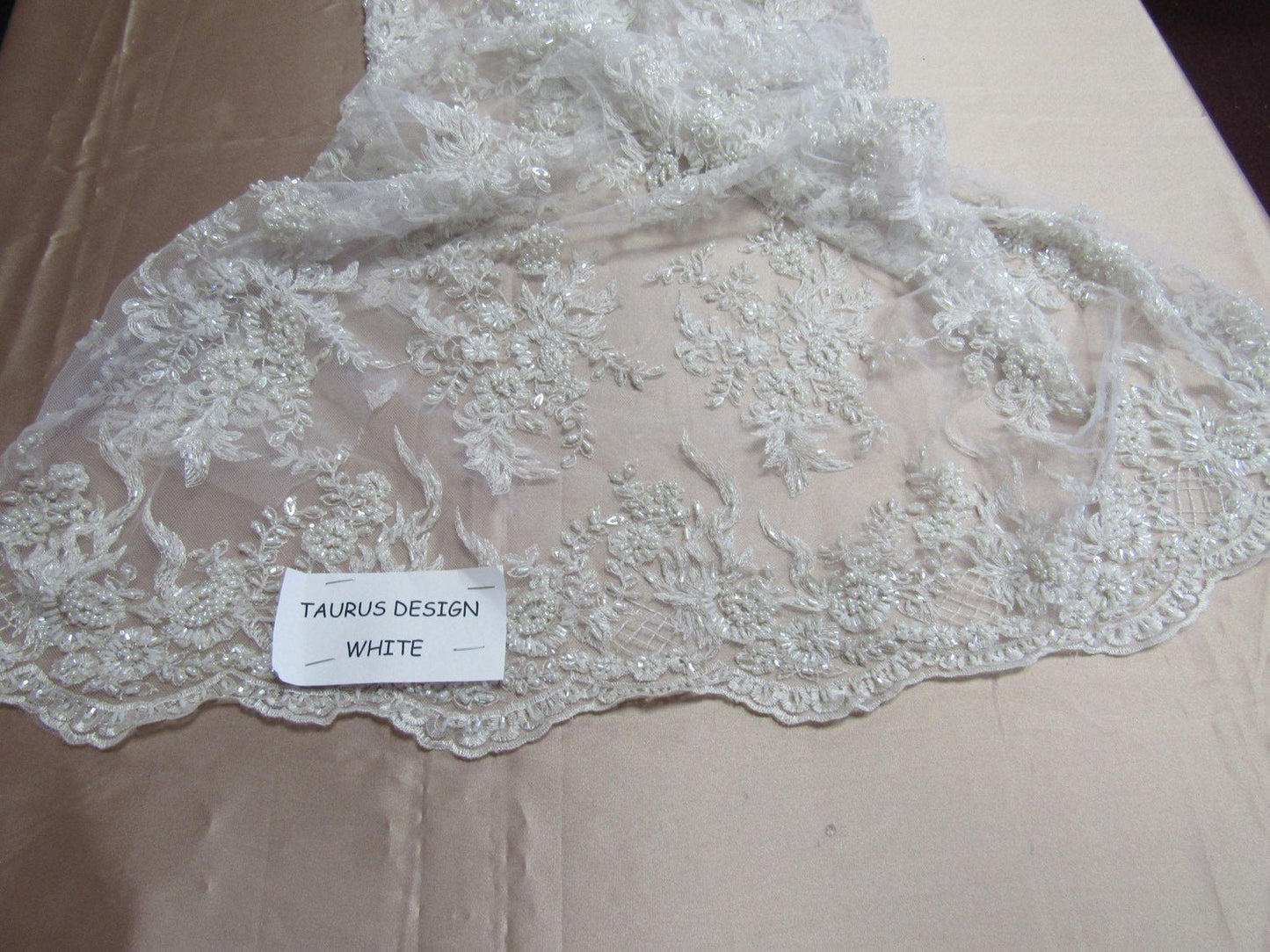 Gorgeous white French design embroider and beaded on a mesh lace. Wedding/Bridal/Prom/Nightgown fabric. - New Creations Fabric & Foam Inc