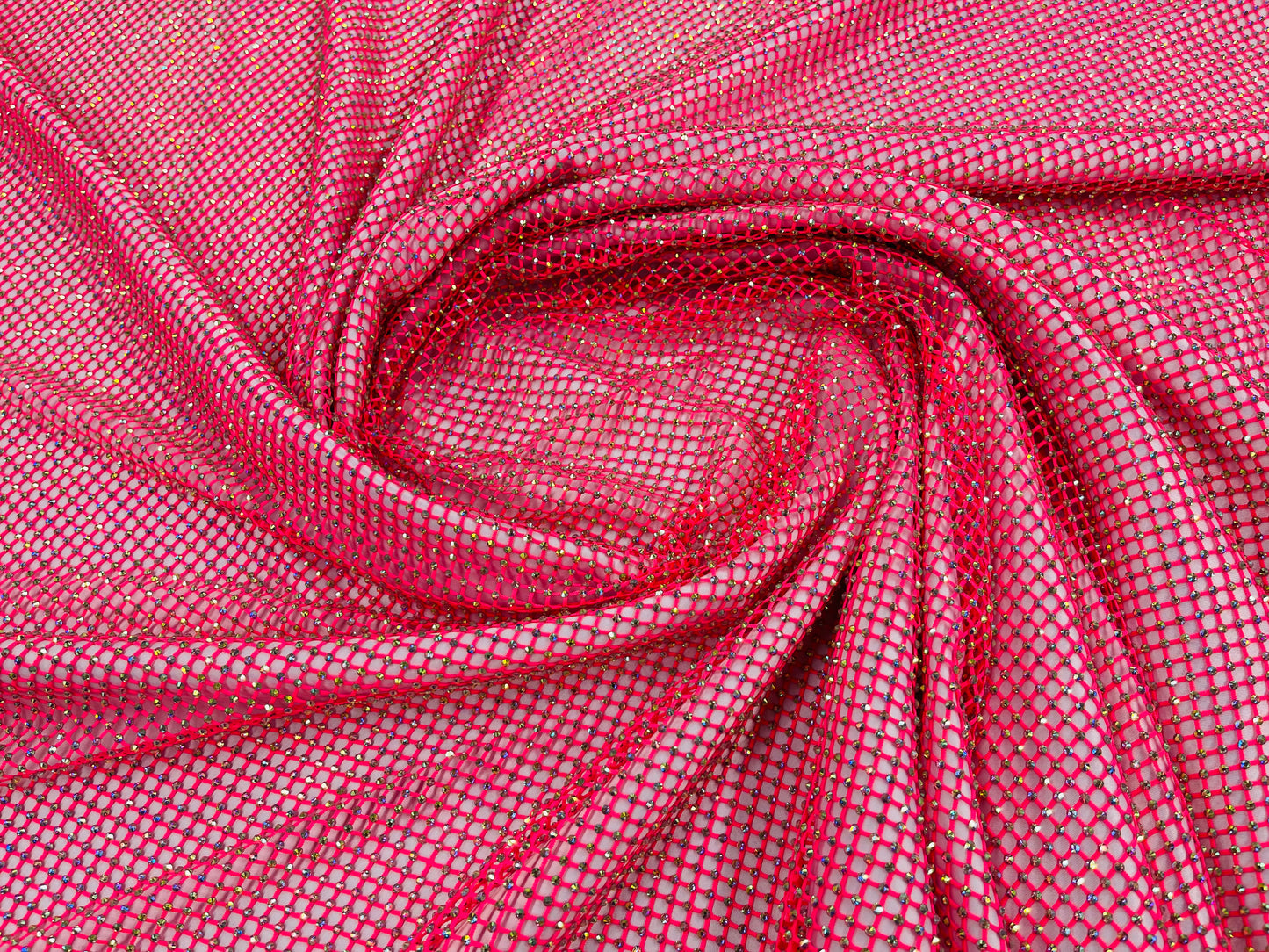 AB Rhinestones on a fish net fabric | New Creation Fabric & Foam Inc.
