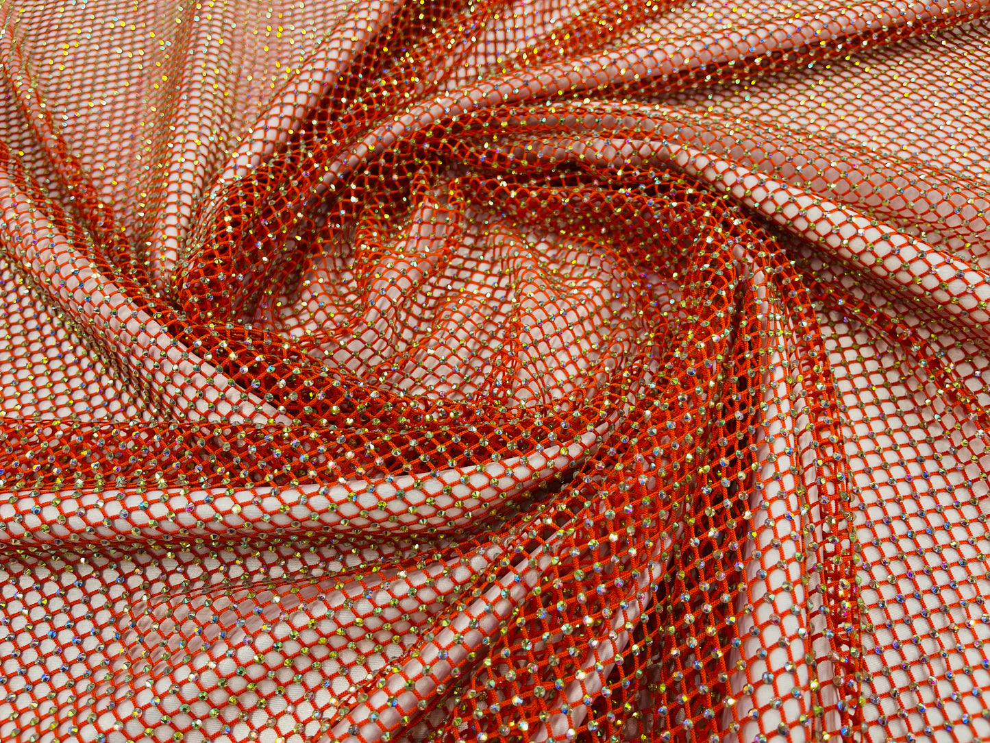AB Rhinestones on a fish net fabric | New Creation Fabric & Foam Inc.
