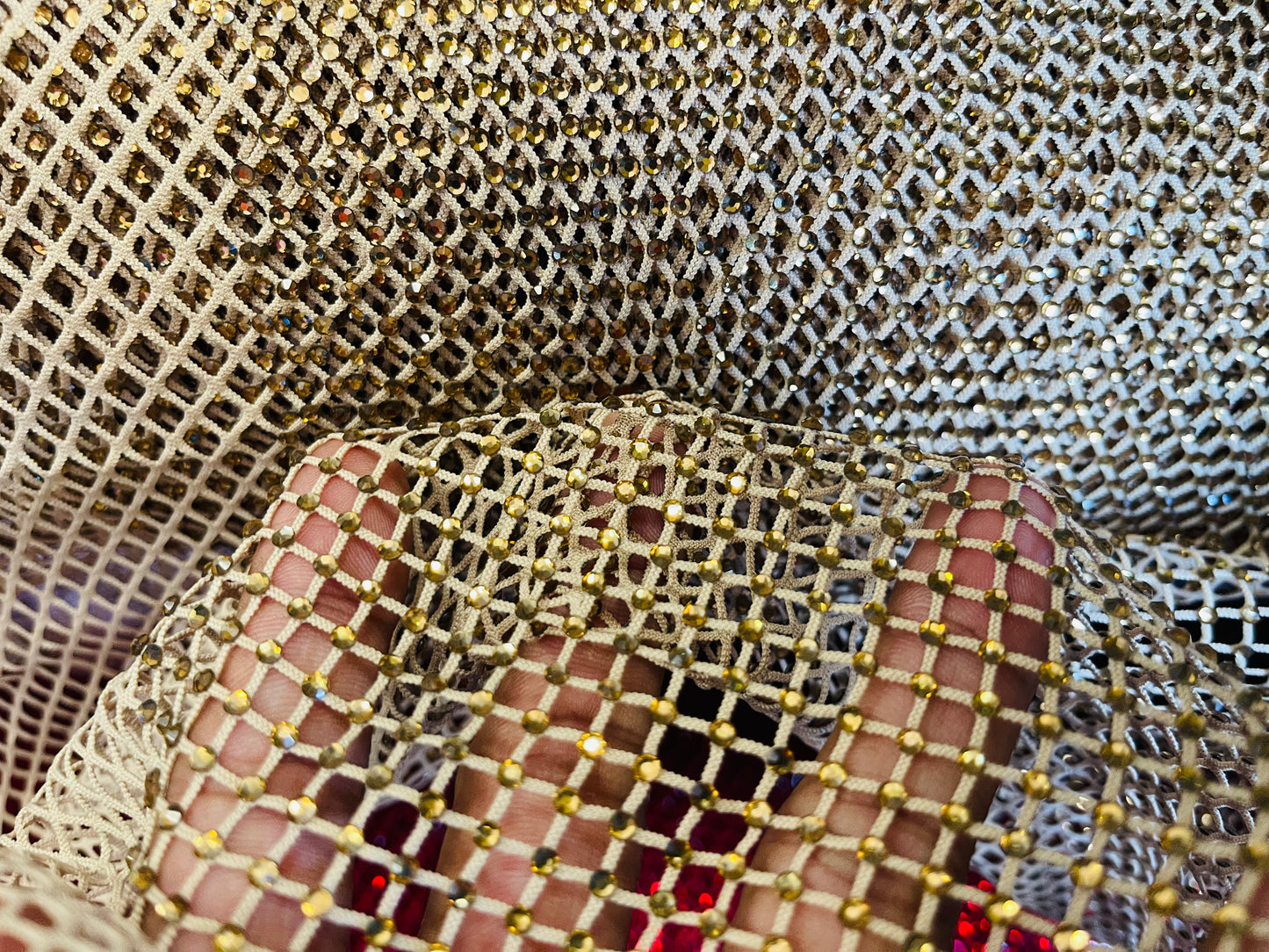 AB Rhinestones on a fish net fabric | New Creation Fabric & Foam Inc.