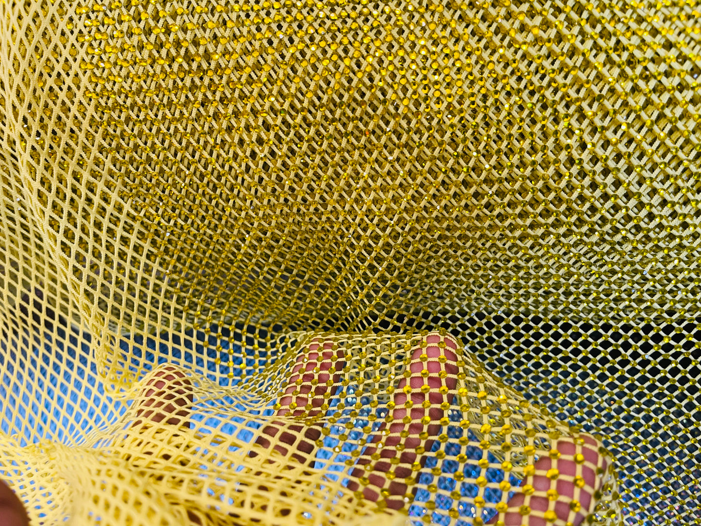 AB Rhinestones on a fish net fabric | New Creation Fabric & Foam Inc.