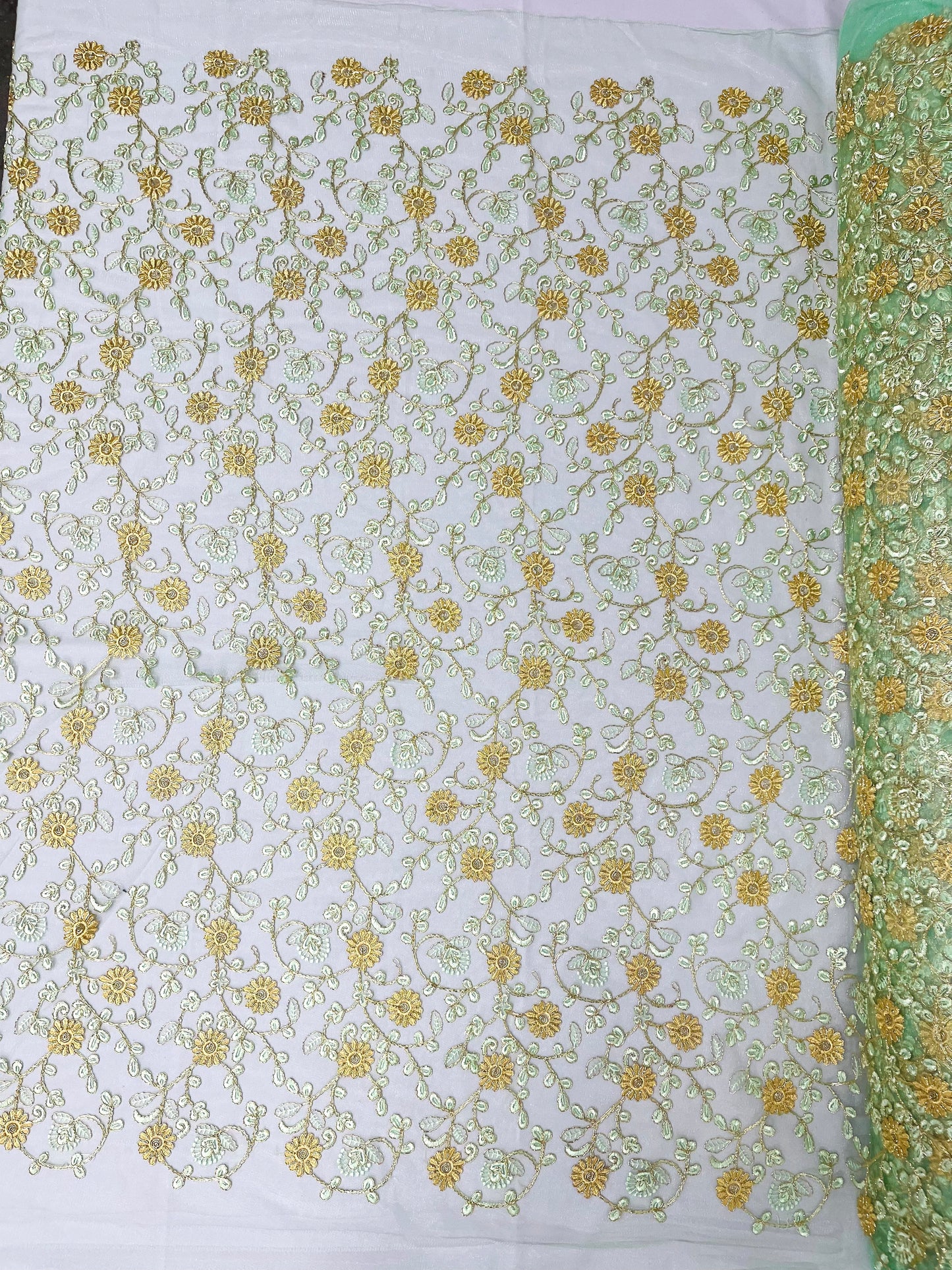 Daisy multi color gold metallic floral design embroider on a red mesh lace-dresses-sold by the yard.