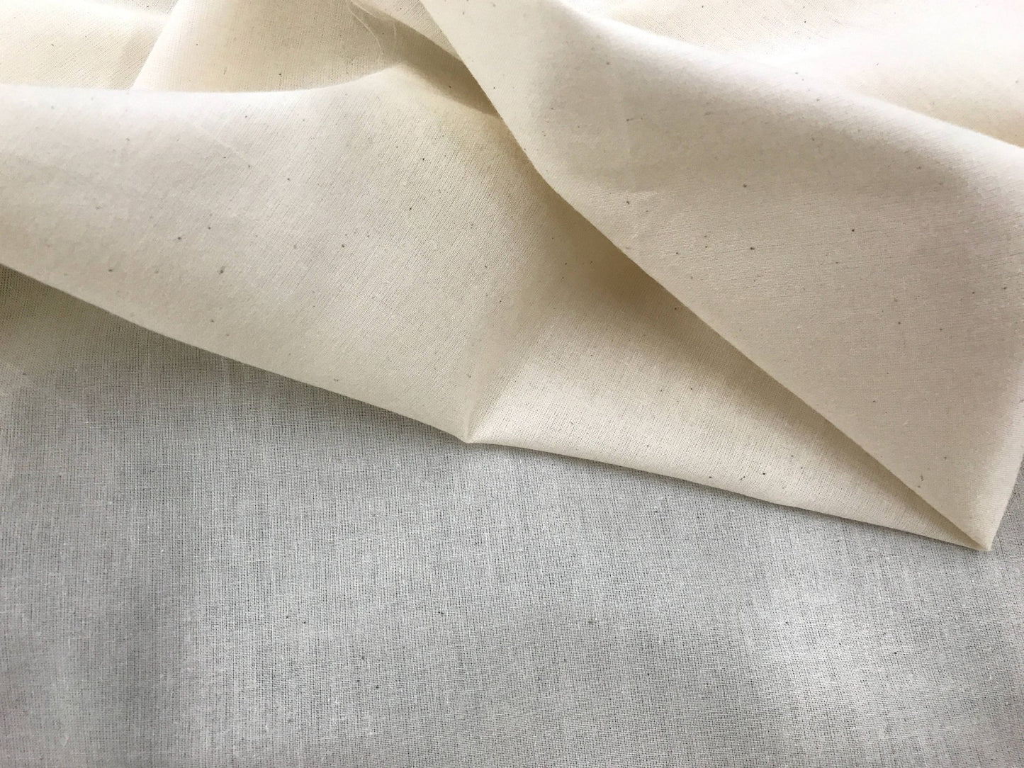 Ivory Muslin natural 100% cotton medium quality unbleached fabric - 45 - 48" wide - pattern maker fabric - sold by the yard. - New Creations Fabric & Foam Inc