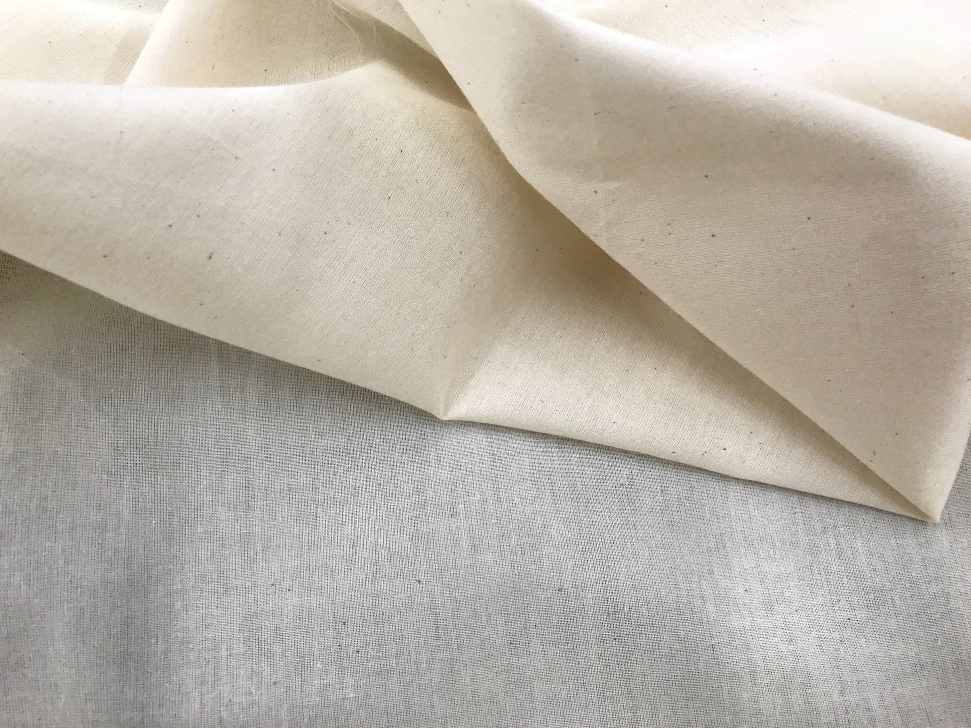 Ivory Muslin natural 100% cotton medium quality unbleached fabric - 45 - 48" wide - pattern maker fabric - sold by the yard. - New Creations Fabric & Foam Inc